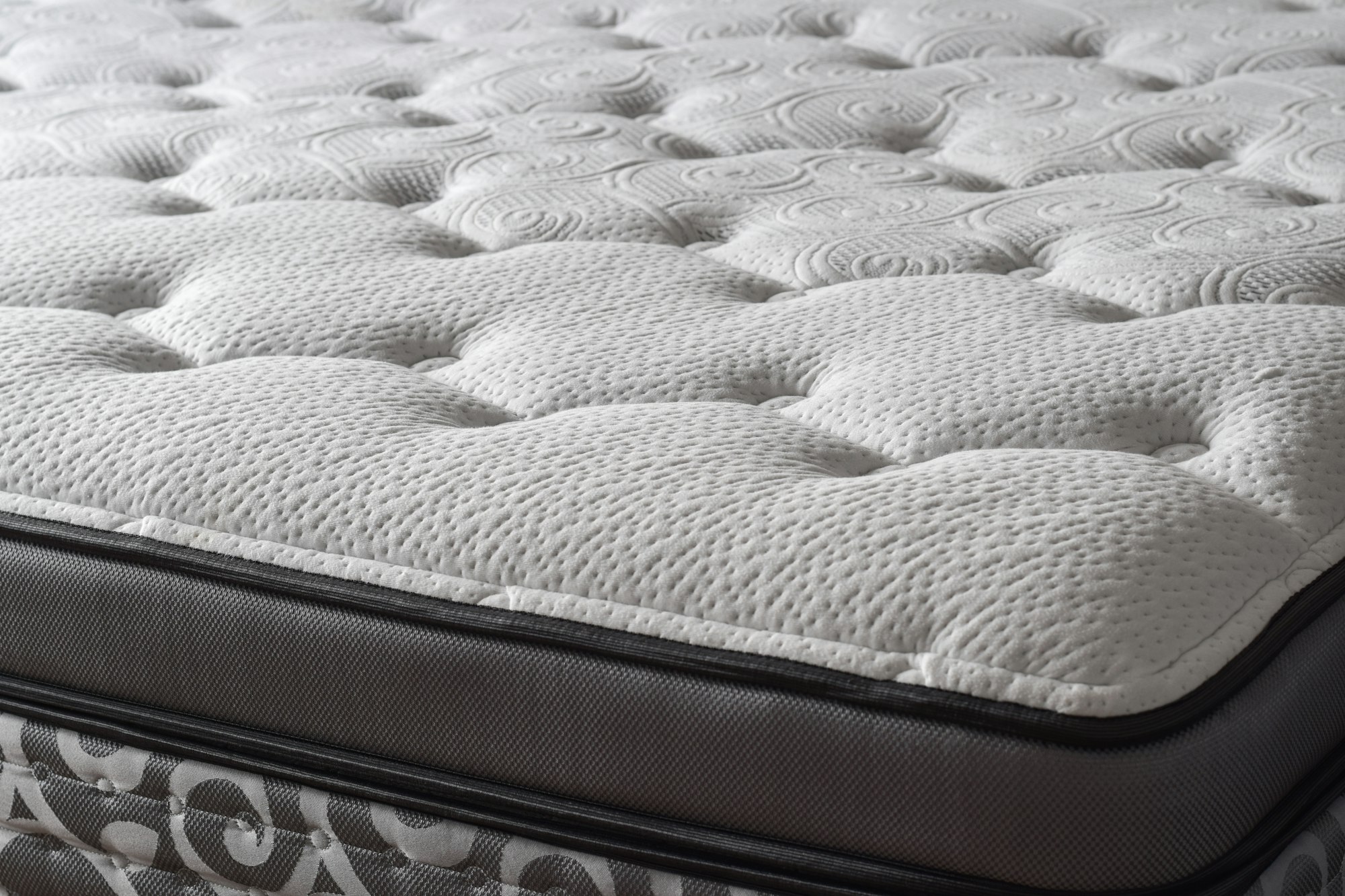 Part of a new white quilted soft mattress